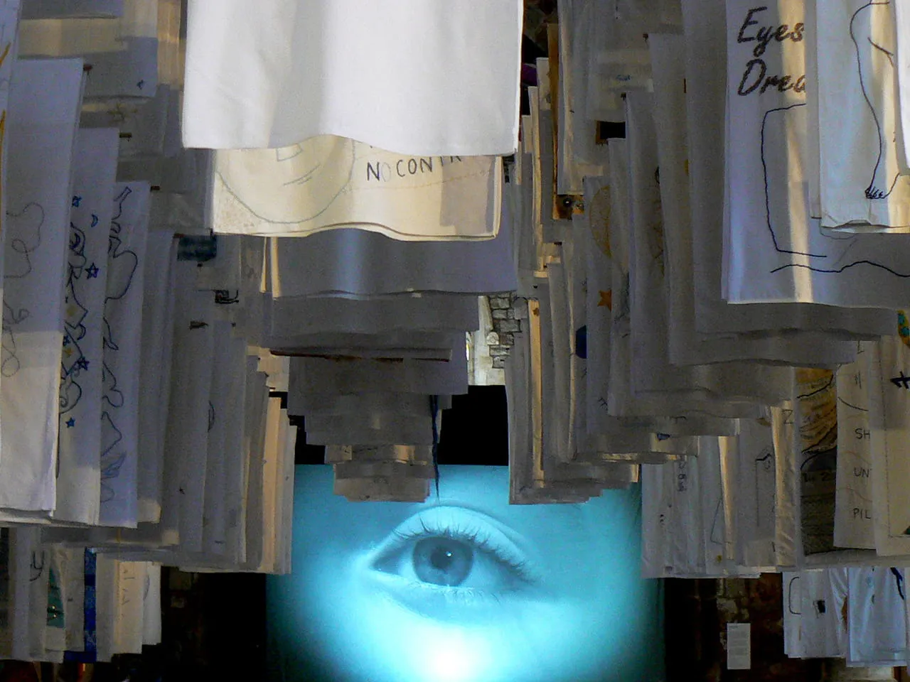 1001 Nights, installation of embroidered pillowcases with video Dormez-vous_ behind, Susan Aldworth, 2017. Shown in The Dark Self, York St Mary’s, 2017. Photograph by Paul Hughes