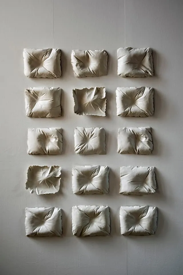 <strong>Evidence of Sleep I</strong>, (detail) installation of 15 porcelain pillows, Susan Aldworth, 2017. Photograph by Paul Hughes.